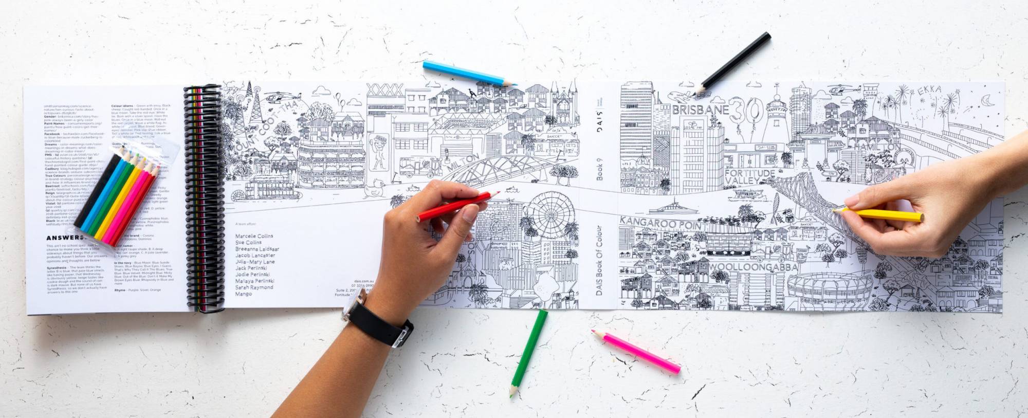 DAIS - Ten Year Project (2010 - 2019) Photo of colouring in page in book with hands colouring in the pages