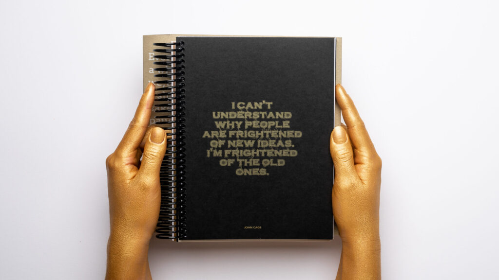 DAIS - Ten Year Project (2010 - 2019) Gold hands holding a black book