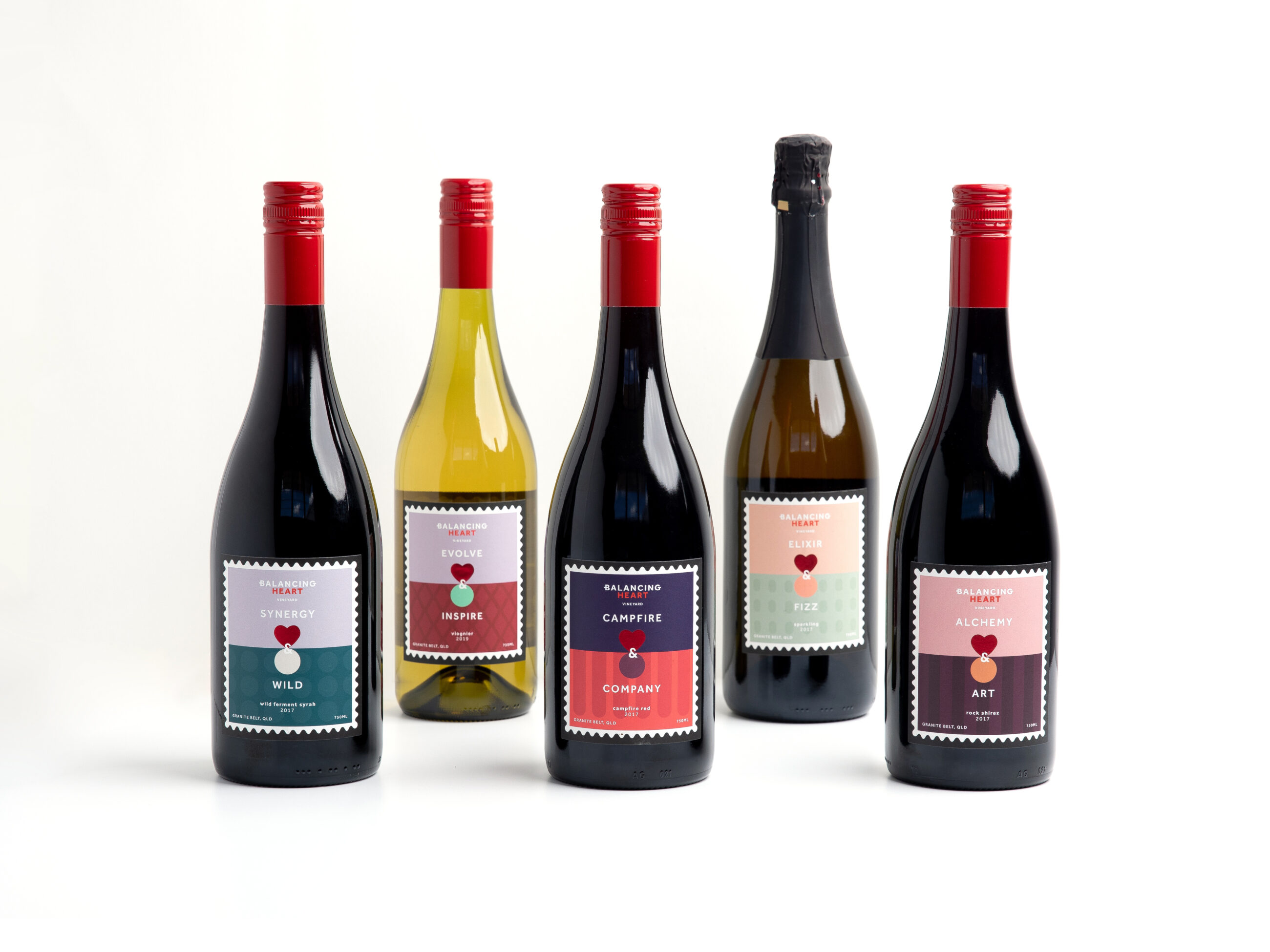 Bottles of Balancing Heart wine stood up on white table
