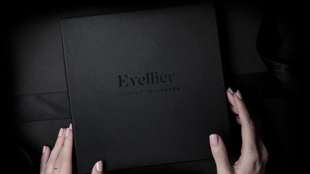 Hands holding black Evellier Elegant Intimates box creating a distinct brand voice
