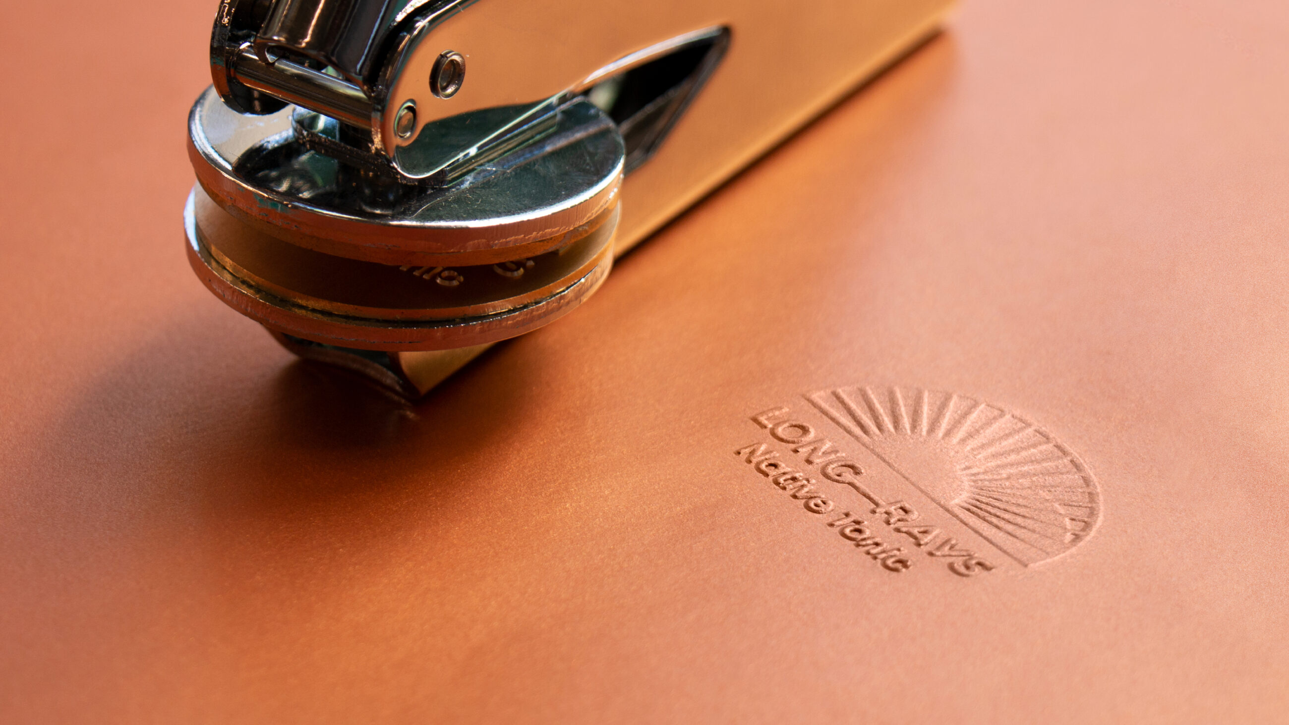 Long Rays Native Tonic debossed brand icon on tan leather