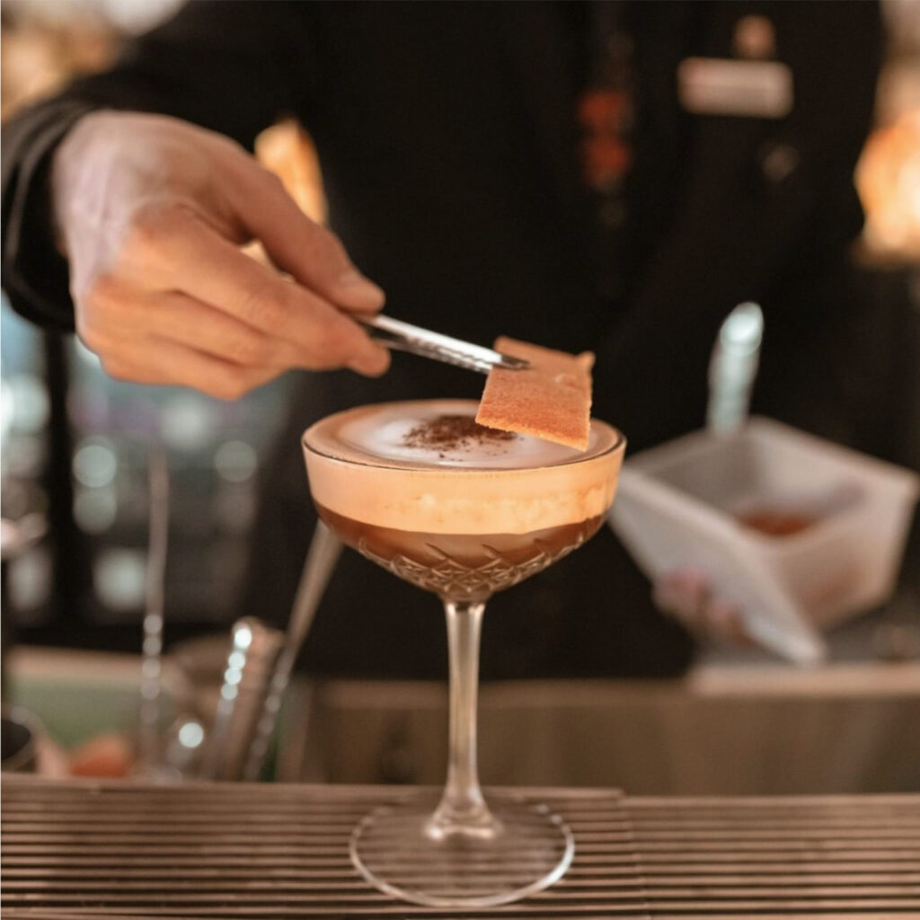 Close up of someone making a cocktail