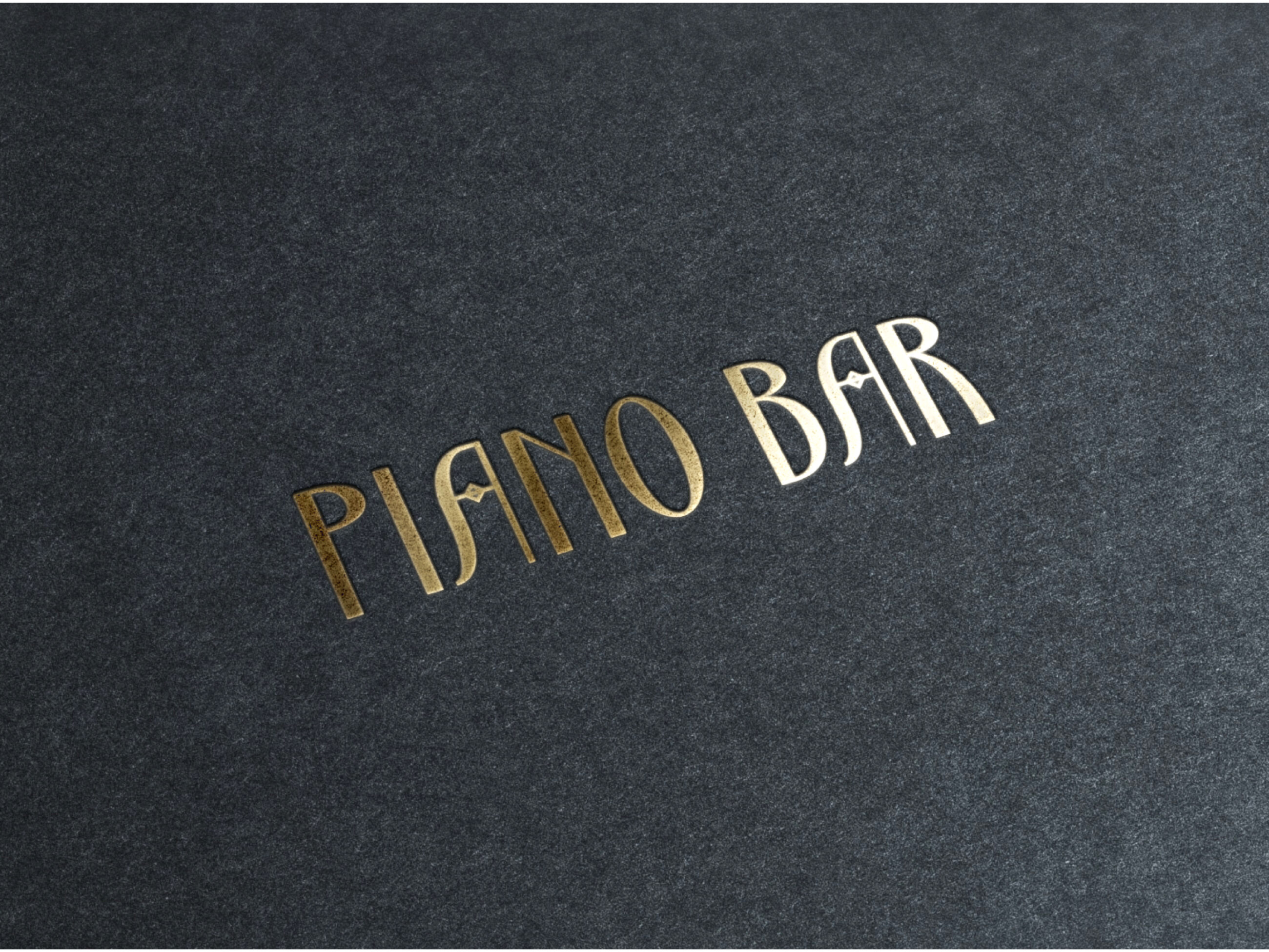 Piano Bar in gold letters on suede background