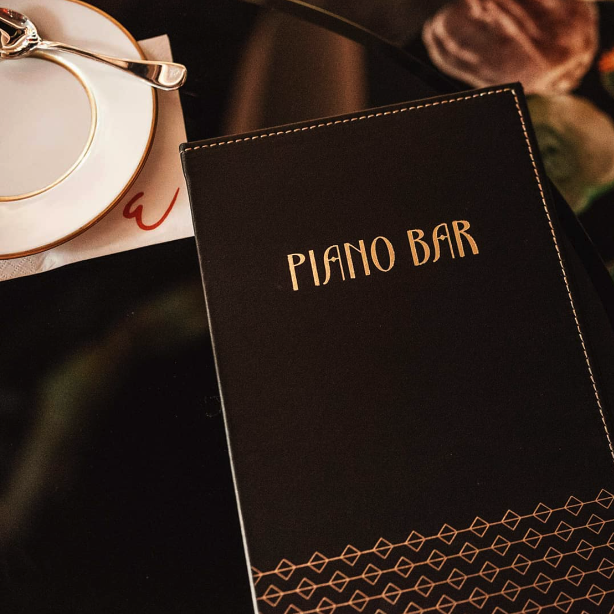 Piano Bar in gold lettering on a menu