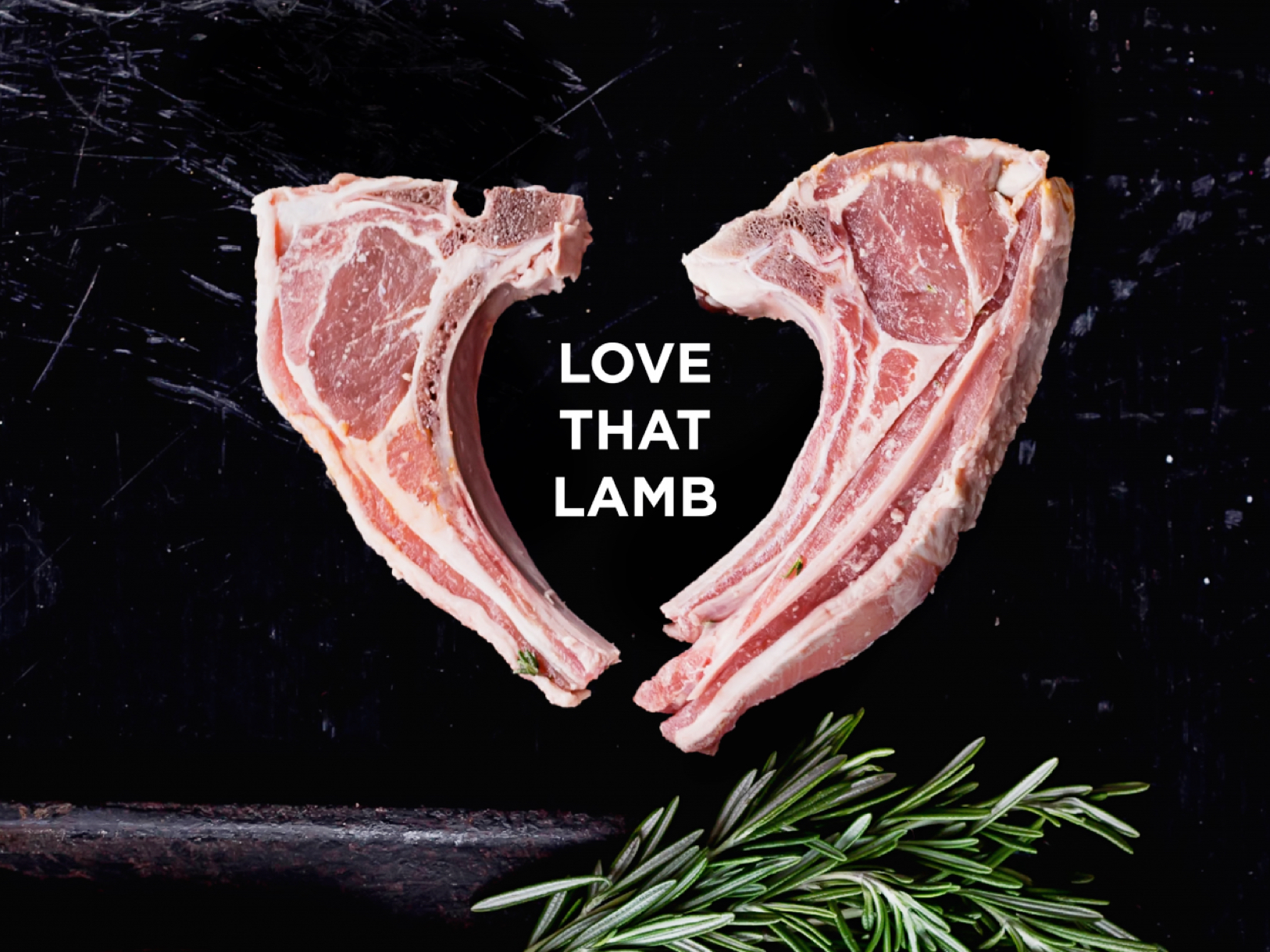 Love that lamb - Campaign image - 2 lamb cutlets on a black background with a sprig of rosemary